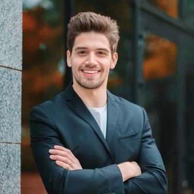 portrait-of-young-successful-confident-businessman-in-the-city-on-office-building-background-man-in_t20_AlnLA0-e1595815123529.jpg